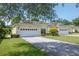 Beautiful single-story home featuring a two-car garage and lush green lawn at 1188 Royal Blvd, Palm Harbor, FL 34684