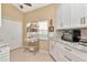 Bright kitchen includes white cabinets, counterspace, and a sunny window with breakfast nook at 1188 Royal Blvd, Palm Harbor, FL 34684