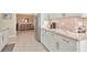 Spacious kitchen features granite countertops, stainless appliances, and white cabinets with ample storage at 1188 Royal Blvd, Palm Harbor, FL 34684