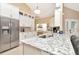Bright kitchen boasts white cabinets, stainless appliances, tile backsplash, and a breakfast bar at 1188 Royal Blvd, Palm Harbor, FL 34684