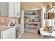 Pantry with shelving for ample storage in a kitchen with white cabinets, countertops and wine rack at 1188 Royal Blvd, Palm Harbor, FL 34684