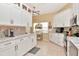 Charming kitchen with white cabinetry, granite countertops, and modern stainless steel appliances at 1188 Royal Blvd, Palm Harbor, FL 34684