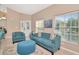 Inviting living room features tile floors, natural light, and stylish blue furniture at 1188 Royal Blvd, Palm Harbor, FL 34684