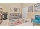 Cozy living room featuring a comfortable gray sofa, patterned rug, and stylish decor at 1188 Royal Blvd, Palm Harbor, FL 34684