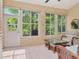 Relaxing sunroom featuring lots of natural light, wicker seating, and tile floors at 1188 Royal Blvd, Palm Harbor, FL 34684