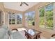 Bright sunroom with tile flooring, multiple windows, and comfortable wicker furniture at 1188 Royal Blvd, Palm Harbor, FL 34684