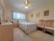 Bright bedroom with a large window and comfortable furnishings, including two chairs at 2311 Brisbane St # 29, Clearwater, FL 33763
