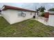 View of the back of the home with brick exterior and a small backyard at 6019 W Fern St, Tampa, FL 33634