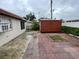 The backyard features a shed, brick patio, small garden, and privacy fence at 6019 W Fern St, Tampa, FL 33634