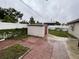 Wide backyard with sheds, patio, grass, and new fence at 6019 W Fern St, Tampa, FL 33634