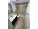 Well-lit bathroom featuring tiled walls, a vanity with storage, and a shower-tub combination at 6019 W Fern St, Tampa, FL 33634