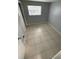 Cozy bedroom featuring tiled floors, natural light, and a neutral color palette at 6019 W Fern St, Tampa, FL 33634