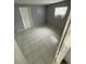 Cozy bedroom with tiled floors, a window unit A/C, and a neutral color scheme at 6019 W Fern St, Tampa, FL 33634