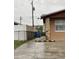 Home's exterior with stone accent column, fenced yard, and off-street parking at 6019 W Fern St, Tampa, FL 33634