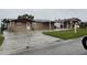 The front exterior of the house and driveway at 6019 W Fern St, Tampa, FL 33634