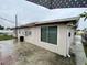 The back exterior of the house with a covered patio and large window at 6019 W Fern St, Tampa, FL 33634
