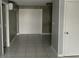 Bright living room featuring modern tile flooring and neutral wall colors at 6019 W Fern St, Tampa, FL 33634