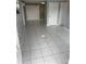 Bright living room featuring modern tile flooring and neutral wall colors at 6019 W Fern St, Tampa, FL 33634