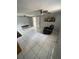 Open-concept living area with tile flooring, ceiling fans, and natural light at 6019 W Fern St, Tampa, FL 33634