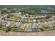 Expansive aerial view of a residential community showcasing well-maintained homes and lush green landscapes at 6335 Cardinal Crest Dr, New Port Richey, FL 34655