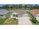 Aerial view of a property surrounded by mature trees and a lush golf course at 6335 Cardinal Crest Dr, New Port Richey, FL 34655