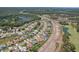 Large aerial shot of a suburban community with homes, grassy lawns, and a nearby highway at 6335 Cardinal Crest Dr, New Port Richey, FL 34655