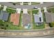 Overhead view of a backyard featuring a screened-in pool, set within a well-maintained residential area at 6335 Cardinal Crest Dr, New Port Richey, FL 34655
