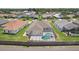 An elevated view showcases the private screened pool and backyard of a home in a quiet neighborhood at 6335 Cardinal Crest Dr, New Port Richey, FL 34655