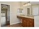Bathroom featuring granite counters, double sinks, a soaking tub, and wood look flooring at 6335 Cardinal Crest Dr, New Port Richey, FL 34655