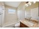Modern bathroom with tub-shower combo, granite vanity, and natural light at 6335 Cardinal Crest Dr, New Port Richey, FL 34655