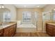 Bathroom with double sinks, garden tub, and a separate shower at 6335 Cardinal Crest Dr, New Port Richey, FL 34655