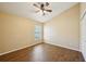 Bedroom boasts high ceilings, wood-look floors, and a bright window at 6335 Cardinal Crest Dr, New Port Richey, FL 34655
