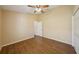Bright bedroom with wood-look tile floor, ceiling fan, and a closet at 6335 Cardinal Crest Dr, New Port Richey, FL 34655