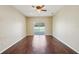 Bedroom with wood floors that steps out to a pool deck at 6335 Cardinal Crest Dr, New Port Richey, FL 34655