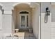 Close-up of the front entrance, featuring a decorative glass door and elegant exterior lighting at 6335 Cardinal Crest Dr, New Port Richey, FL 34655