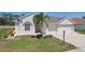 Well-maintained home with green lawn and mature palm and manicured landscaping at 6335 Cardinal Crest Dr, New Port Richey, FL 34655