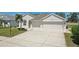 Front exterior view of a home featuring a manicured lawn and a two-car garage at 6335 Cardinal Crest Dr, New Port Richey, FL 34655