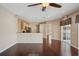 Open floor plan featuring hardwood floors, kitchen bar and view to sliding glass doors at 6335 Cardinal Crest Dr, New Port Richey, FL 34655