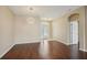 Open-concept living room boasts gleaming hardwood floors and a decorative front door at 6335 Cardinal Crest Dr, New Port Richey, FL 34655
