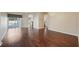 Spacious living room featuring hardwood floors, sliding glass doors to pool, and an open floor plan at 6335 Cardinal Crest Dr, New Port Richey, FL 34655