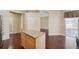 Hardwood floored living room with kitchen island and view to sliding glass doors at 6335 Cardinal Crest Dr, New Port Richey, FL 34655