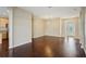 Hardwood floored living room with open floor plan, neutral paint and decorative front door at 6335 Cardinal Crest Dr, New Port Richey, FL 34655