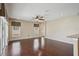 Hardwood floored living room with ceiling fan and view to sliding glass doors at 6335 Cardinal Crest Dr, New Port Richey, FL 34655