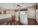 Open-concept living room boasts gleaming hardwood floors and sliding glass doors at 6335 Cardinal Crest Dr, New Port Richey, FL 34655