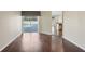 Spacious living room featuring hardwood floors, sliding glass doors to pool, and an open floor plan at 6335 Cardinal Crest Dr, New Port Richey, FL 34655