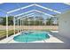 Screened in pool featuring an attached spa and green perimeter views at 6335 Cardinal Crest Dr, New Port Richey, FL 34655
