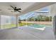 A covered patio leads to a screened in pool with lush views at 6335 Cardinal Crest Dr, New Port Richey, FL 34655