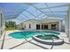 Backyard oasis with private screened-in pool and attached spa at 6335 Cardinal Crest Dr, New Port Richey, FL 34655