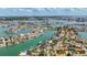 Expansive aerial view showcasing waterfront homes, lush greenery, and picturesque canals in a vibrant community at 1120 81St S St, St Petersburg, FL 33707