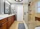 Nicely remodeled bathroom with walk-in shower, a glass partition, and stylish vanity at 1120 81St S St, St Petersburg, FL 33707